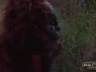 Wonderful fabulous fascinating blonde call girl with big tits fucking with a gorilla in nature